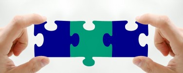 Photo of person holding three interlocking puzzle pieces